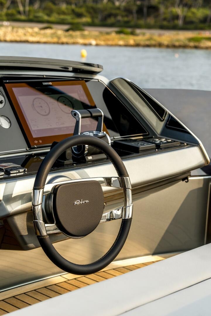 a steering wheel and a book on a boat aboard GECUA Yacht for Sale