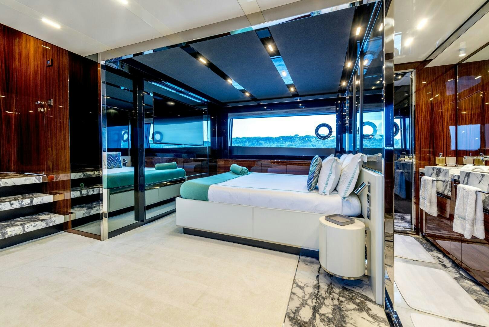 a room with a bed and a large mirror aboard GECUA Yacht for Sale