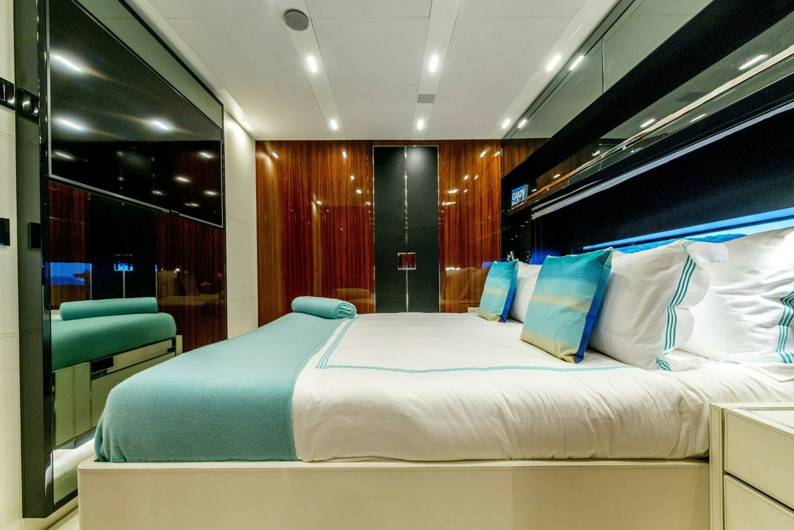 a bed with blue pillows aboard GECUA Yacht for Sale