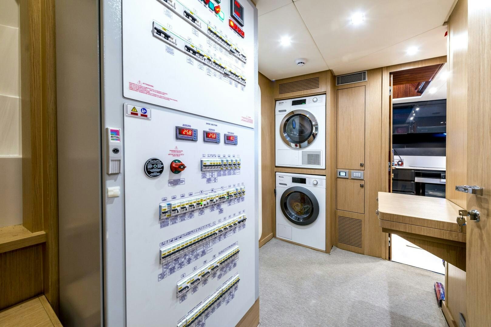 a room with a washing machine and dryer aboard GECUA Yacht for Sale