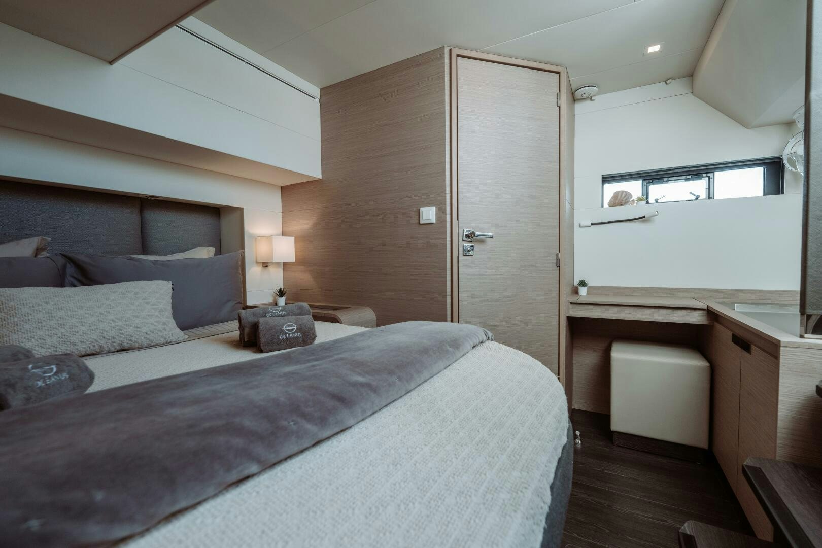 a bedroom with a bed and a desk aboard OCEANUS Yacht for Sale