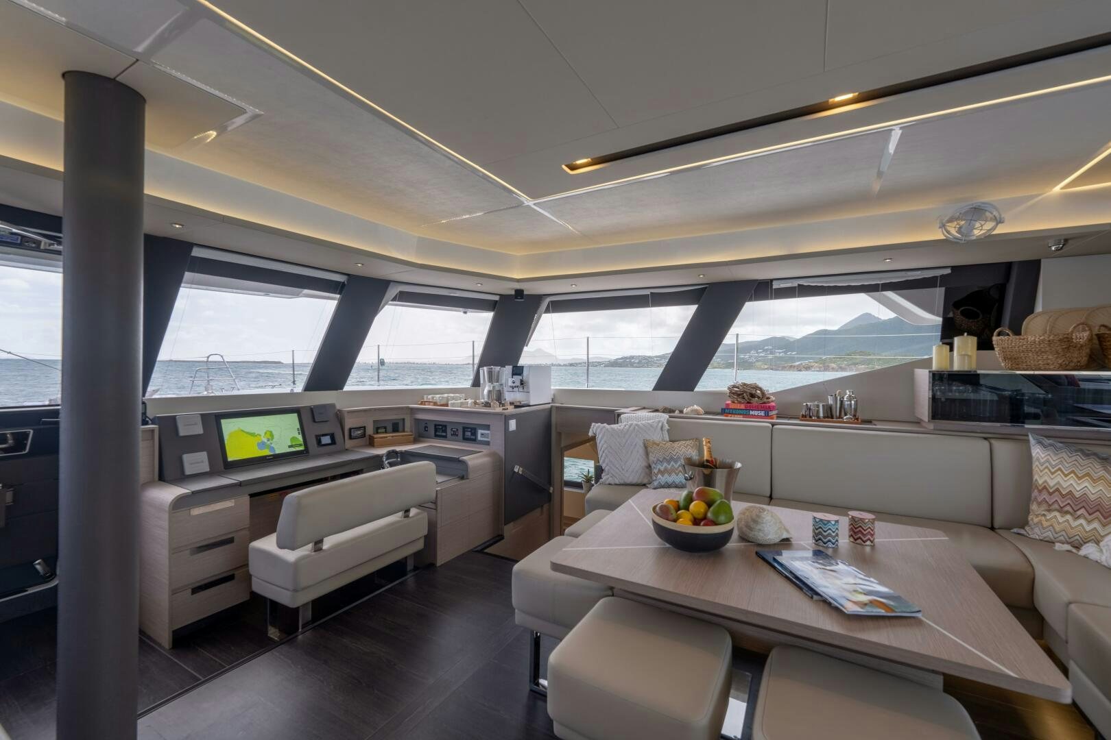 a room with a table and chairs aboard OCEANUS Yacht for Sale