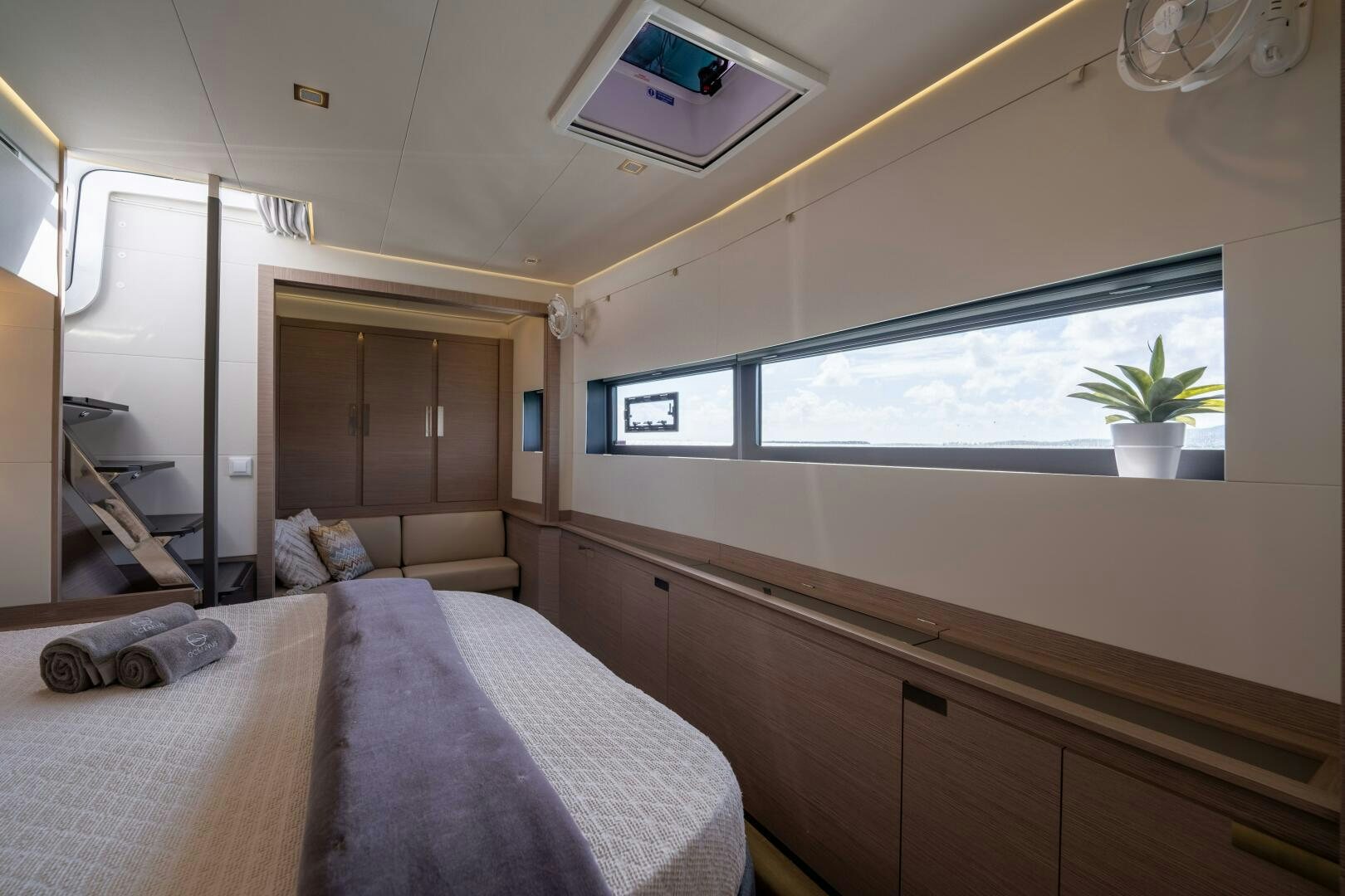 a bedroom with a bed and a television on the wall aboard OCEANUS Yacht for Sale