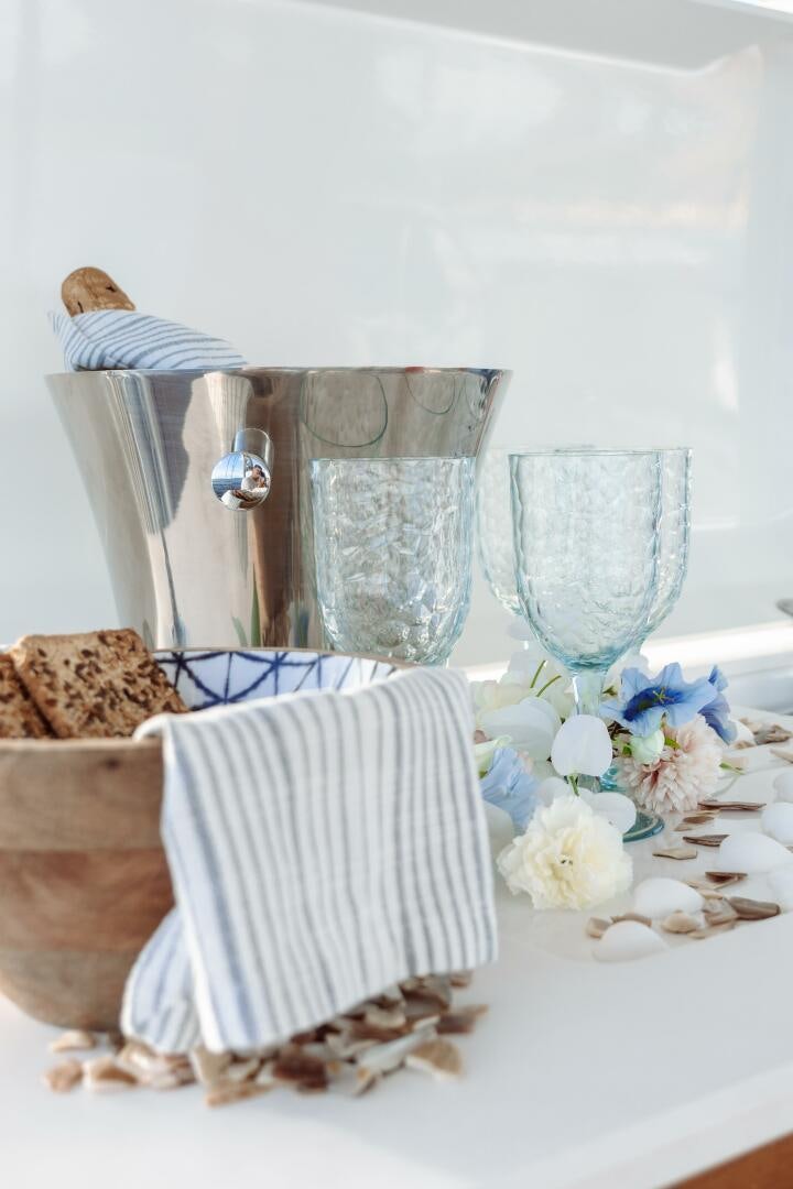 a table with a glass and a plate of food aboard OCEANUS Yacht for Sale