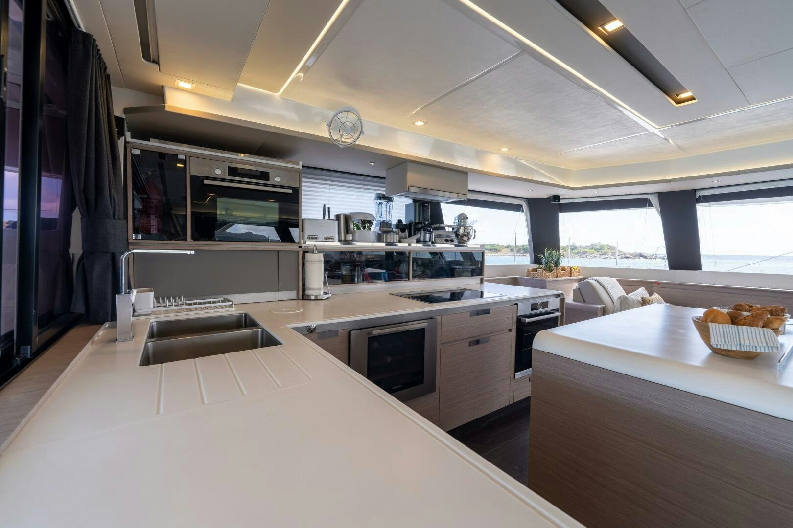 a kitchen with white counter tops aboard OCEANUS Yacht for Sale