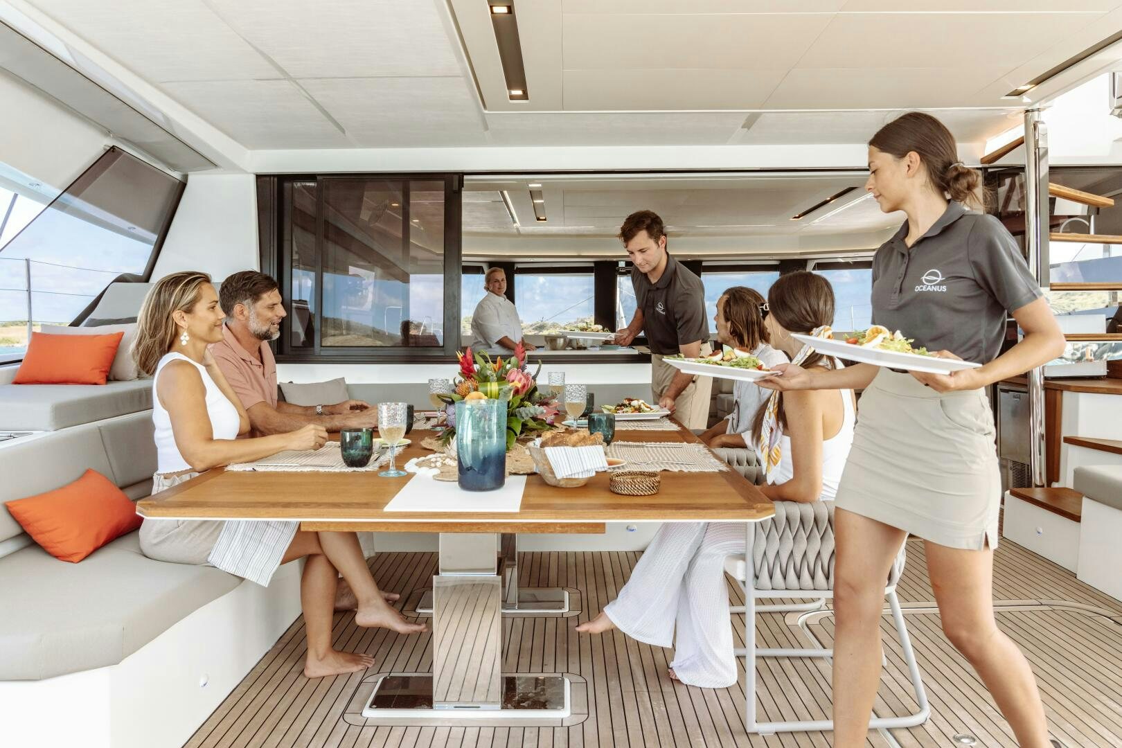 a group of people eating at a restaurant aboard OCEANUS Yacht for Sale