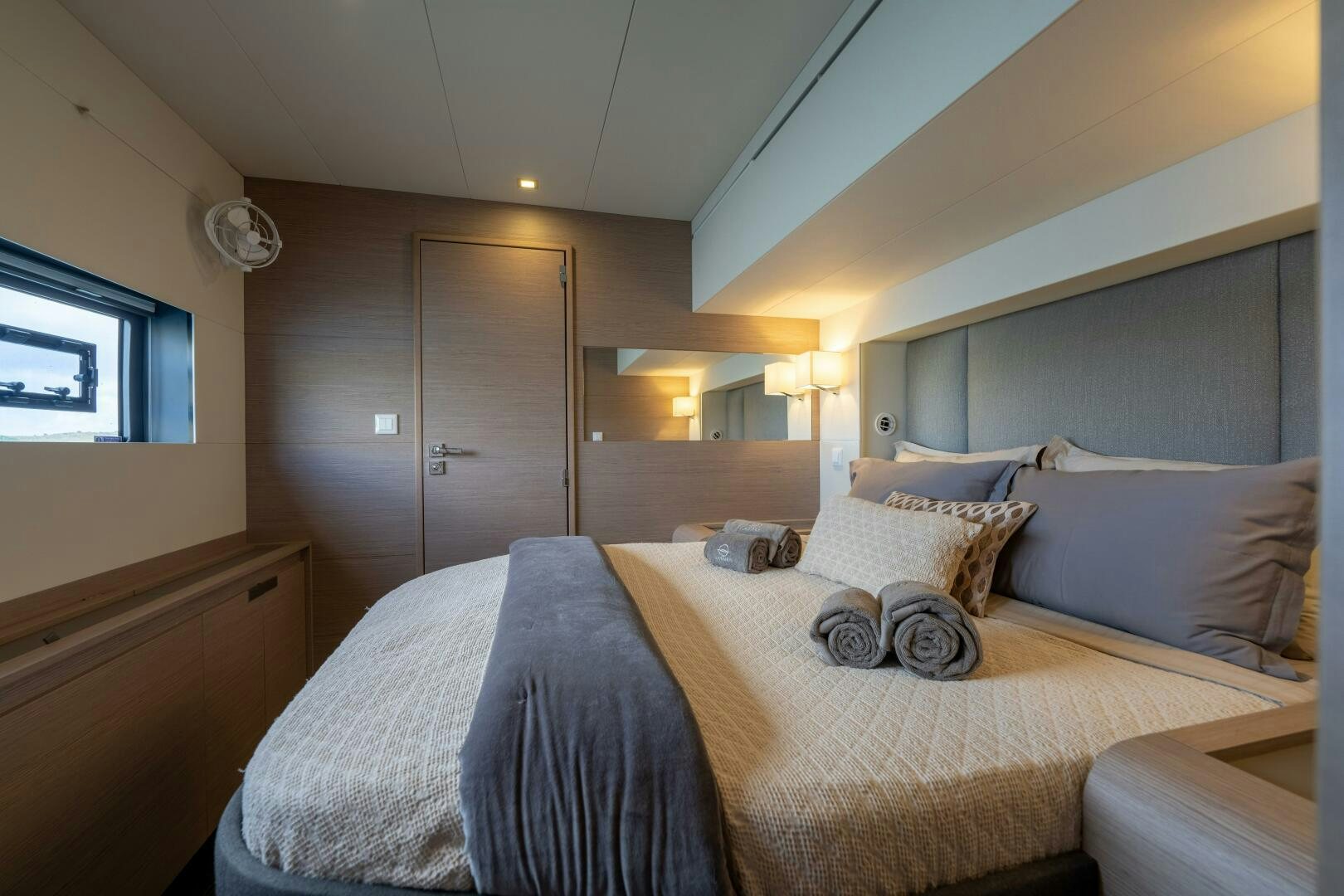 a bed with a white comforter aboard OCEANUS Yacht for Sale