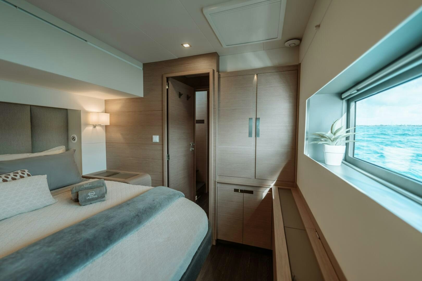a bedroom with a bed and a window aboard OCEANUS Yacht for Sale