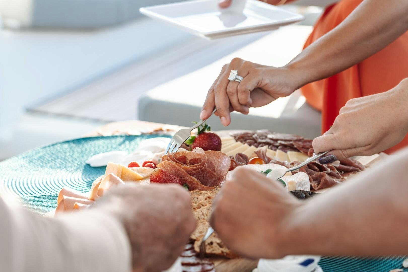 a person cutting a piece of meat aboard OCEANUS Yacht for Sale