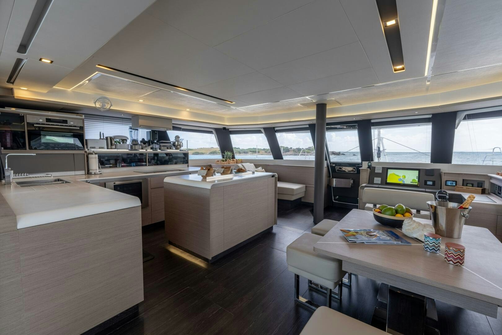a large room with a table and chairs aboard OCEANUS Yacht for Sale