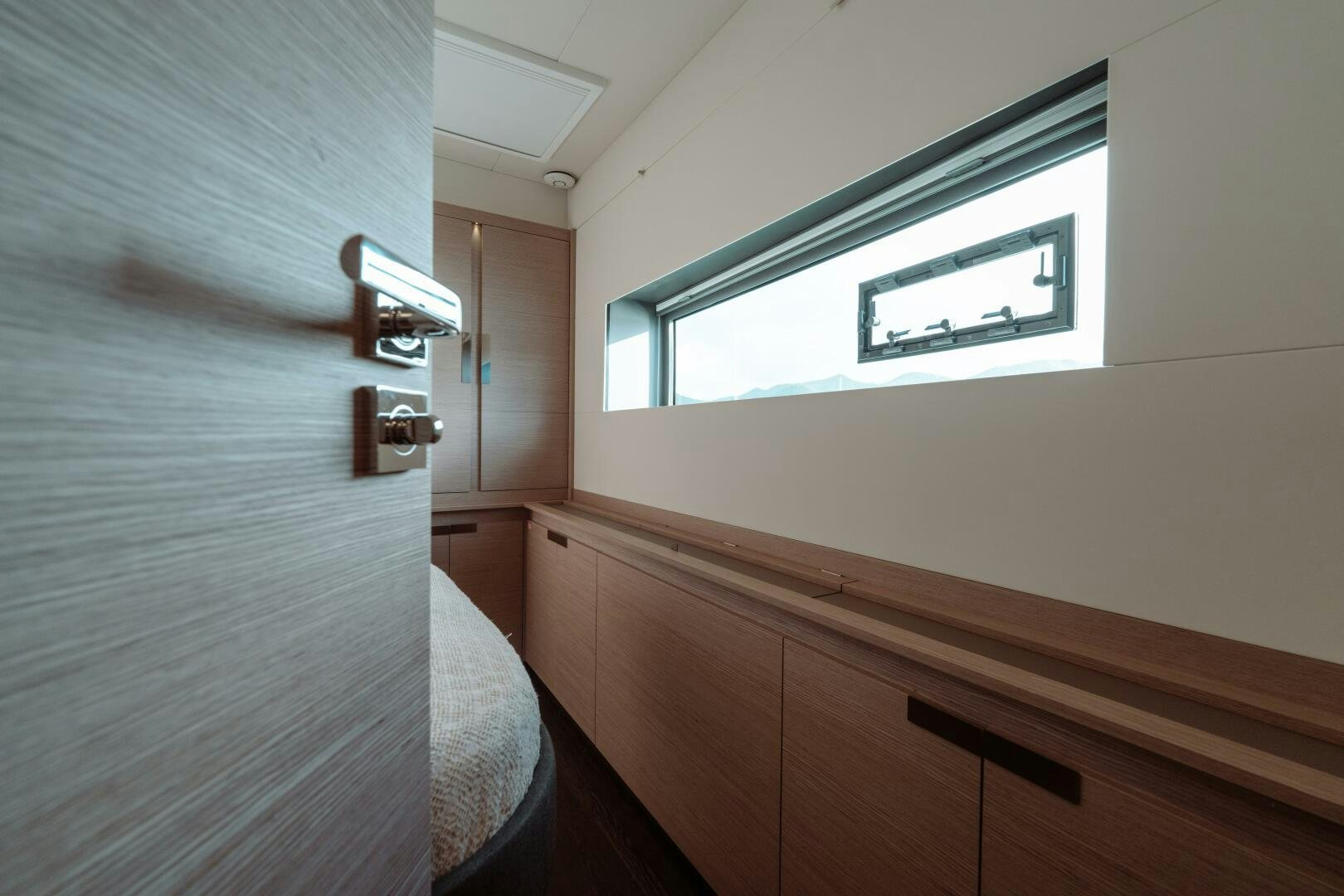 a room with a bed and a window aboard OCEANUS Yacht for Sale