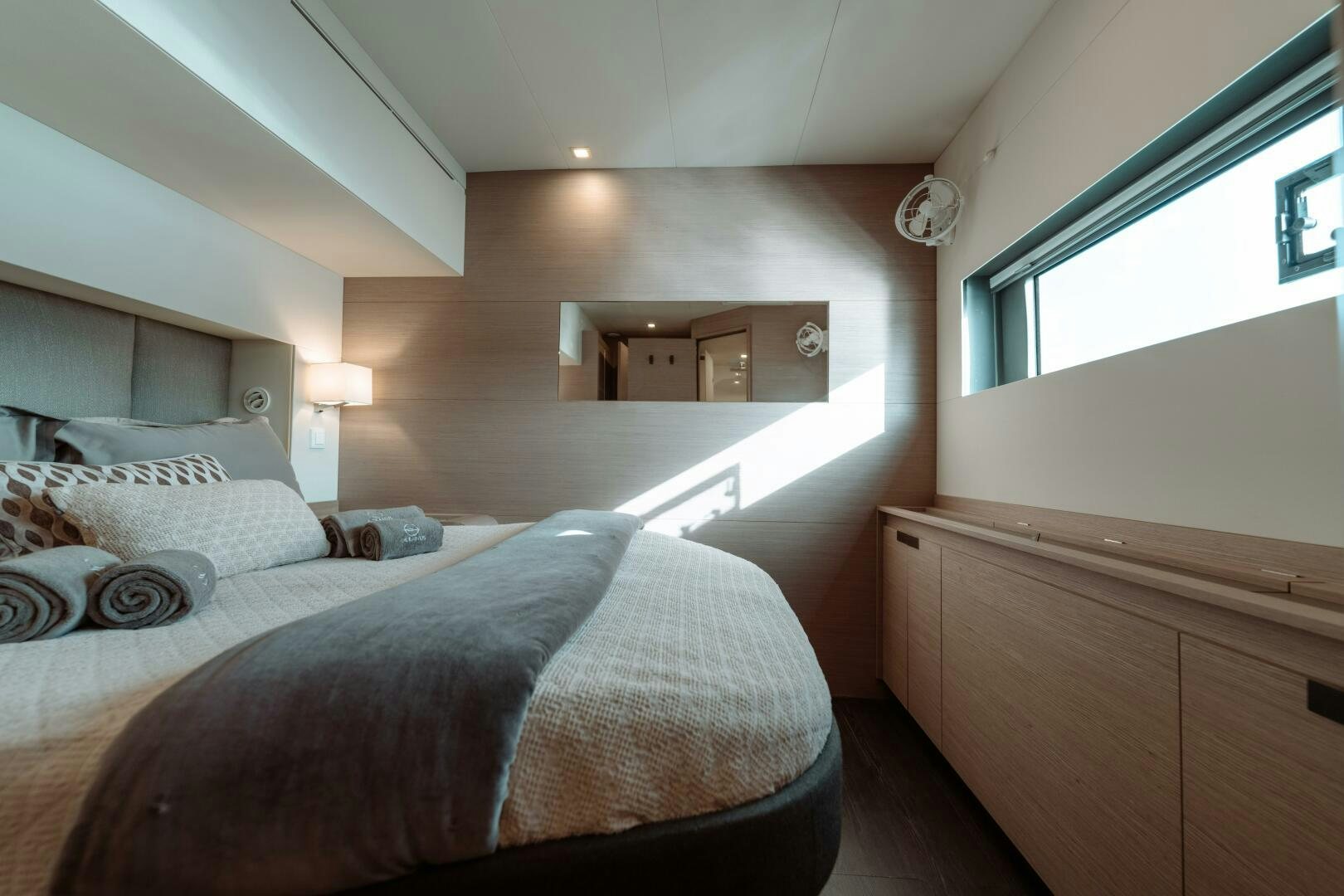 a bedroom with a bed and a dresser aboard OCEANUS Yacht for Sale