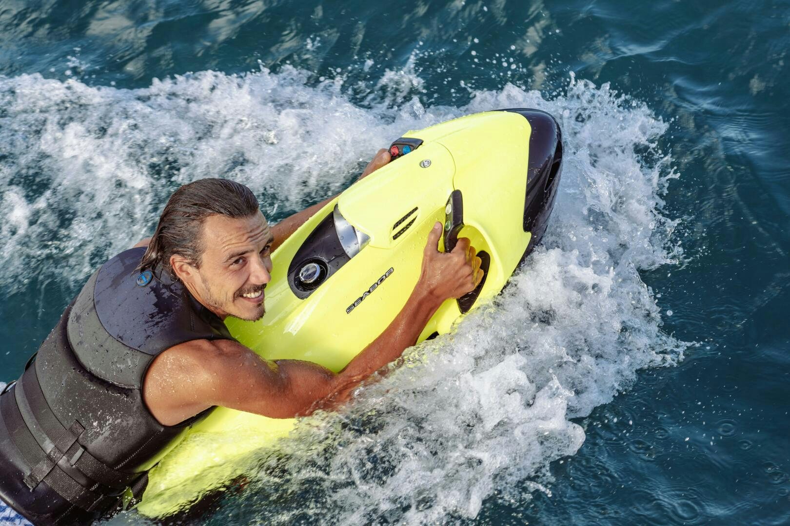 a man riding a surfboard aboard OCEANUS Yacht for Sale