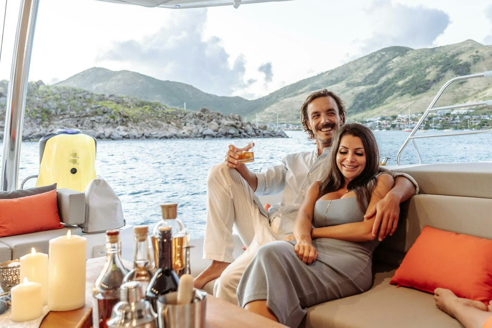a man and woman sitting on a boat with a woman holding a hot dog aboard OCEANUS Yacht for Sale