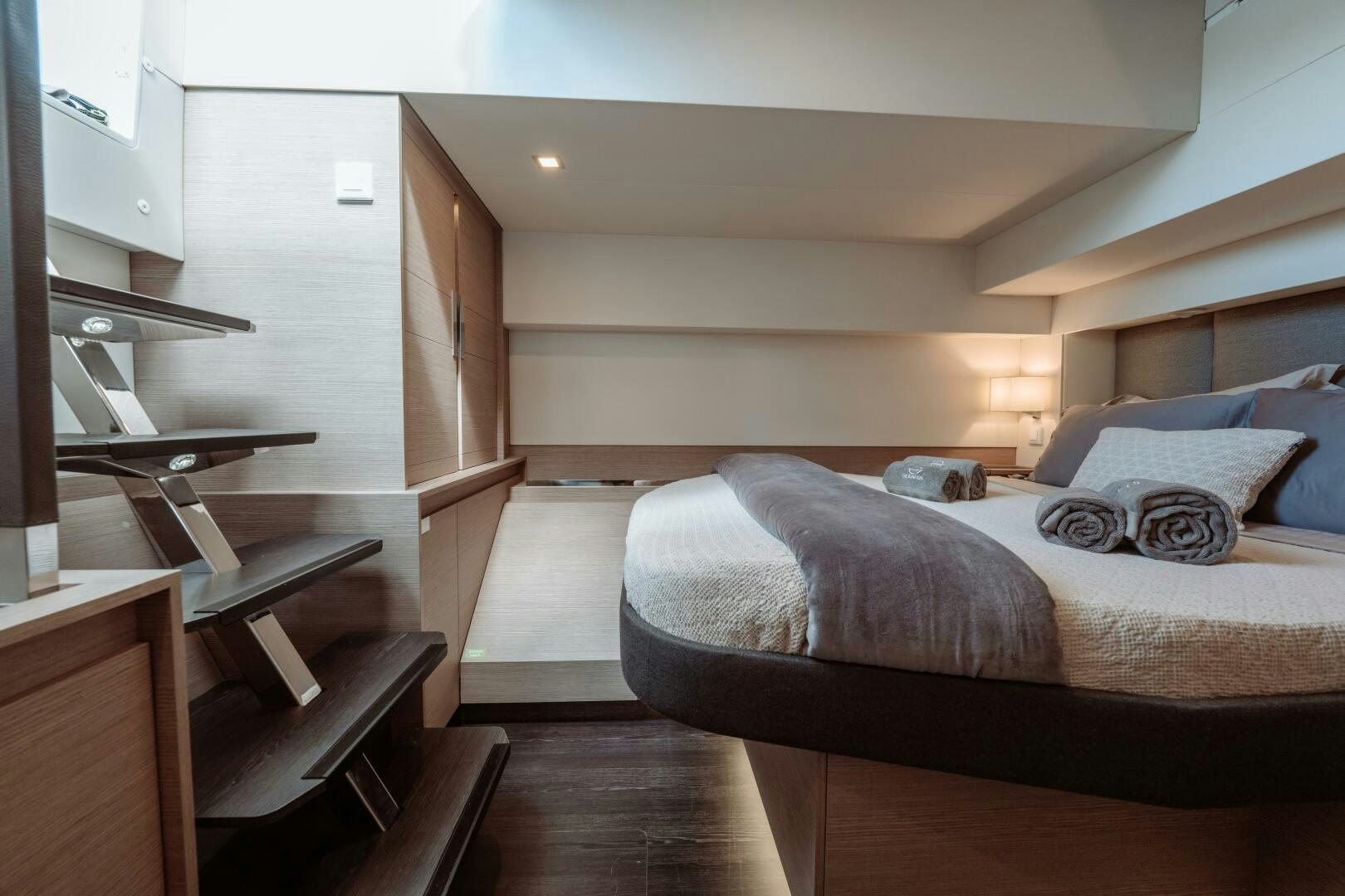 a bedroom with a bed and desk aboard OCEANUS Yacht for Sale