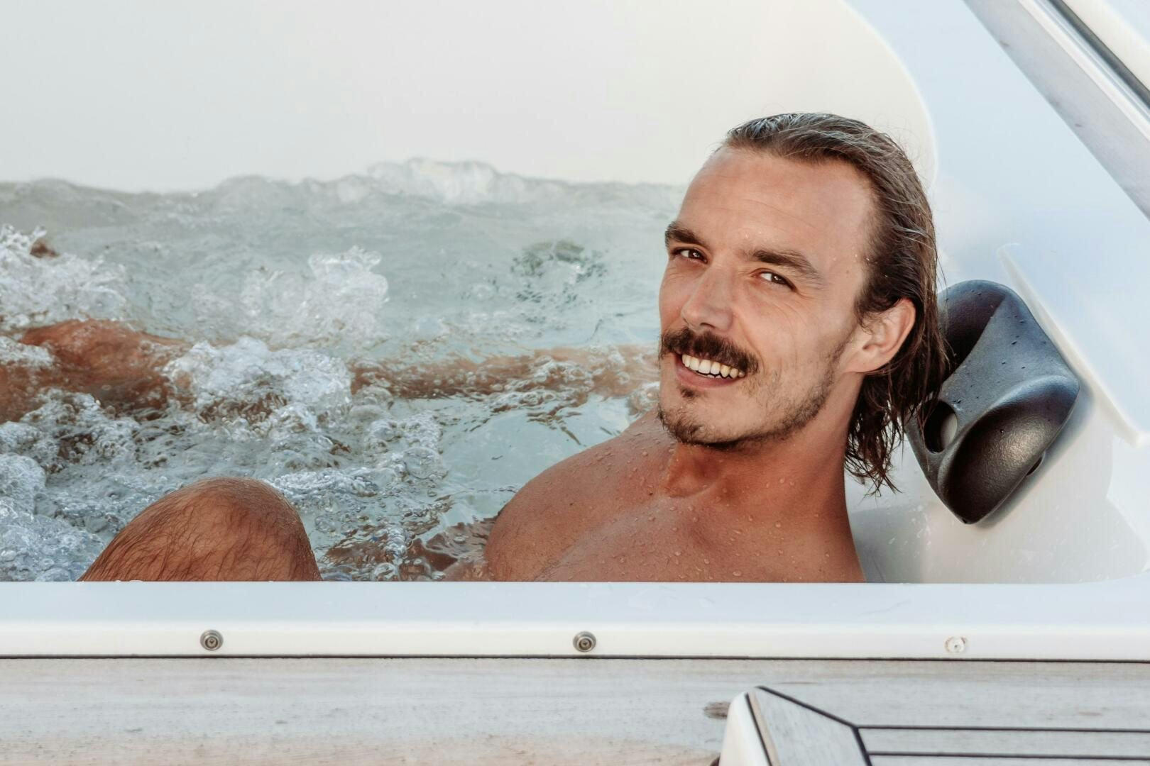 a person with a mustache smiling aboard OCEANUS Yacht for Sale