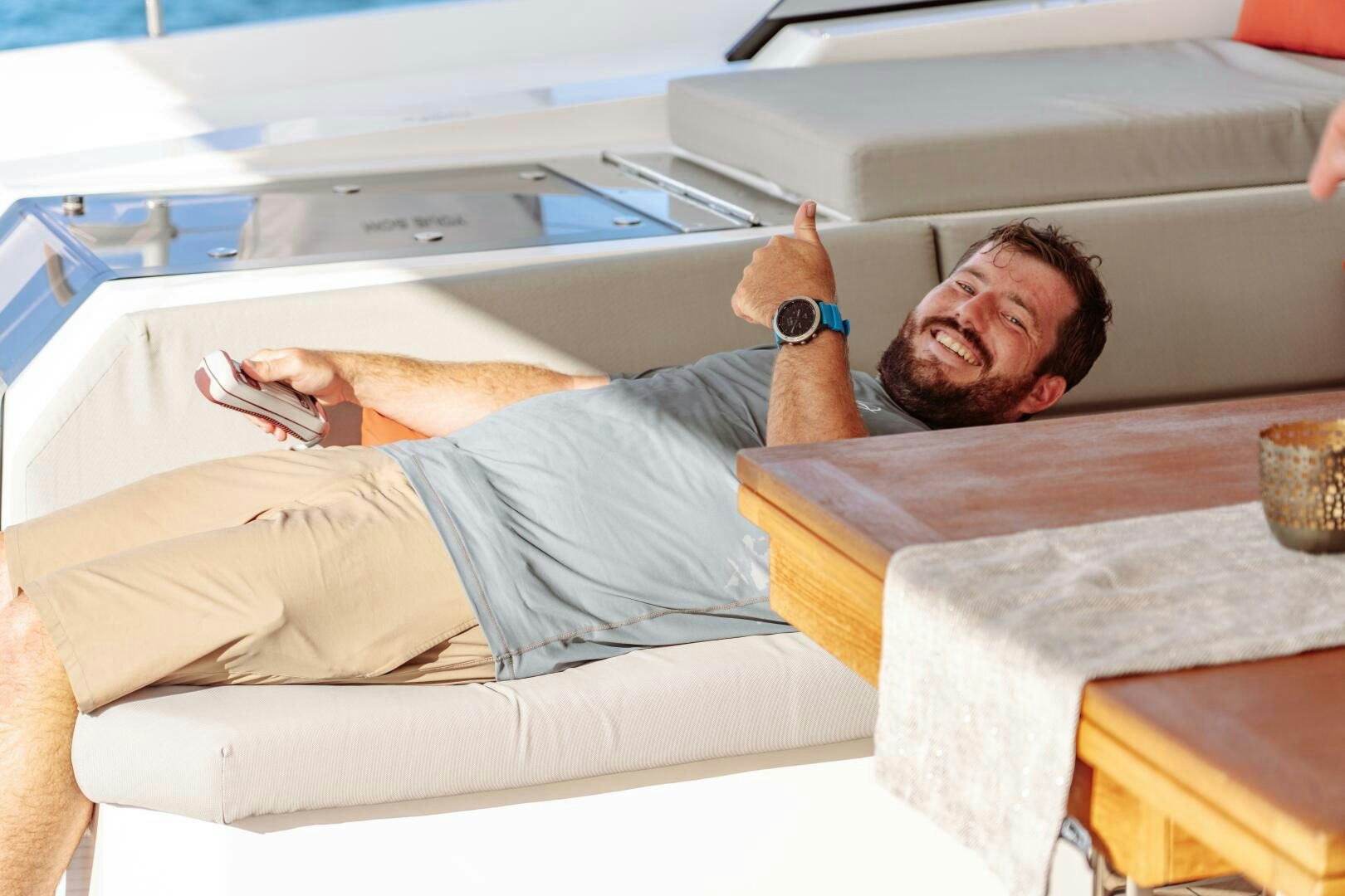 a man lying on a bed aboard OCEANUS Yacht for Sale