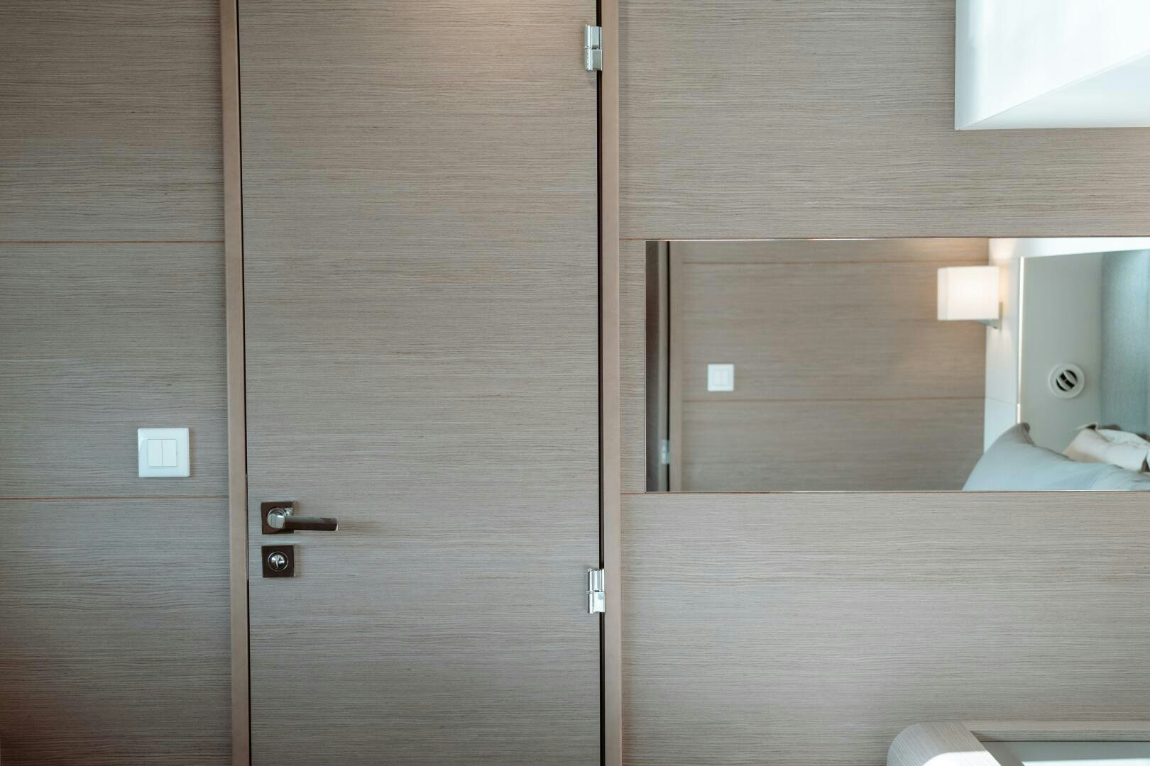 a room with a bed and a closet aboard OCEANUS Yacht for Sale