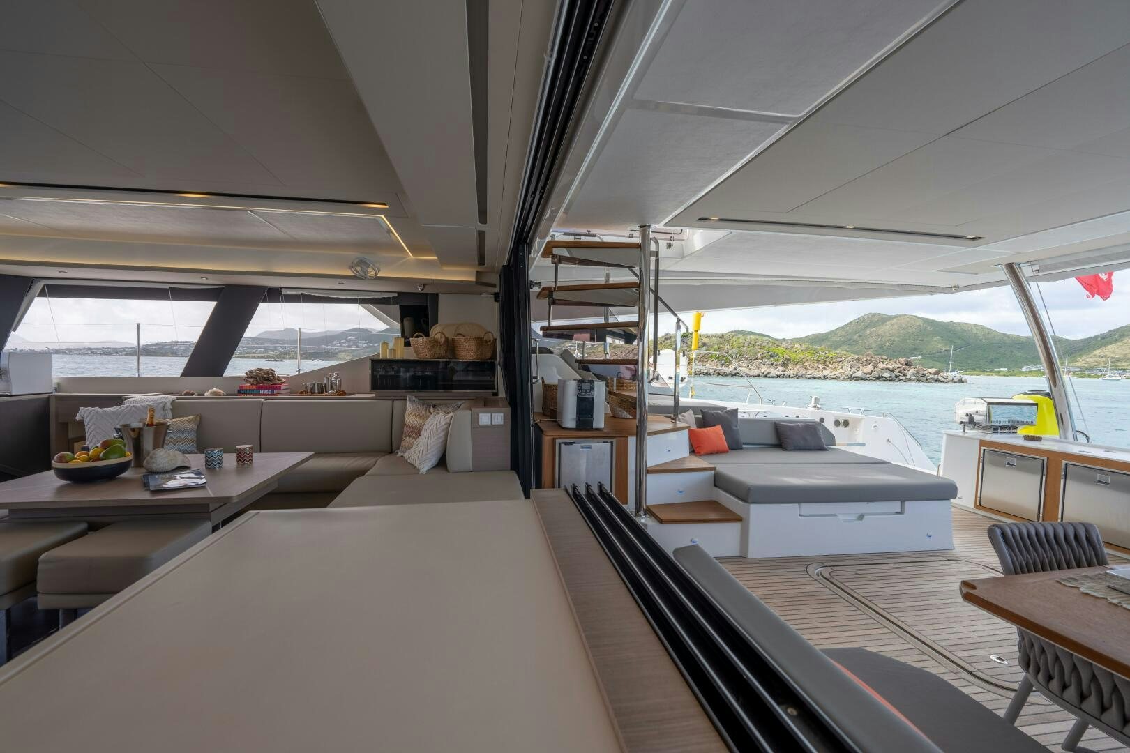 a room with a couch and a table and a pool aboard OCEANUS Yacht for Sale