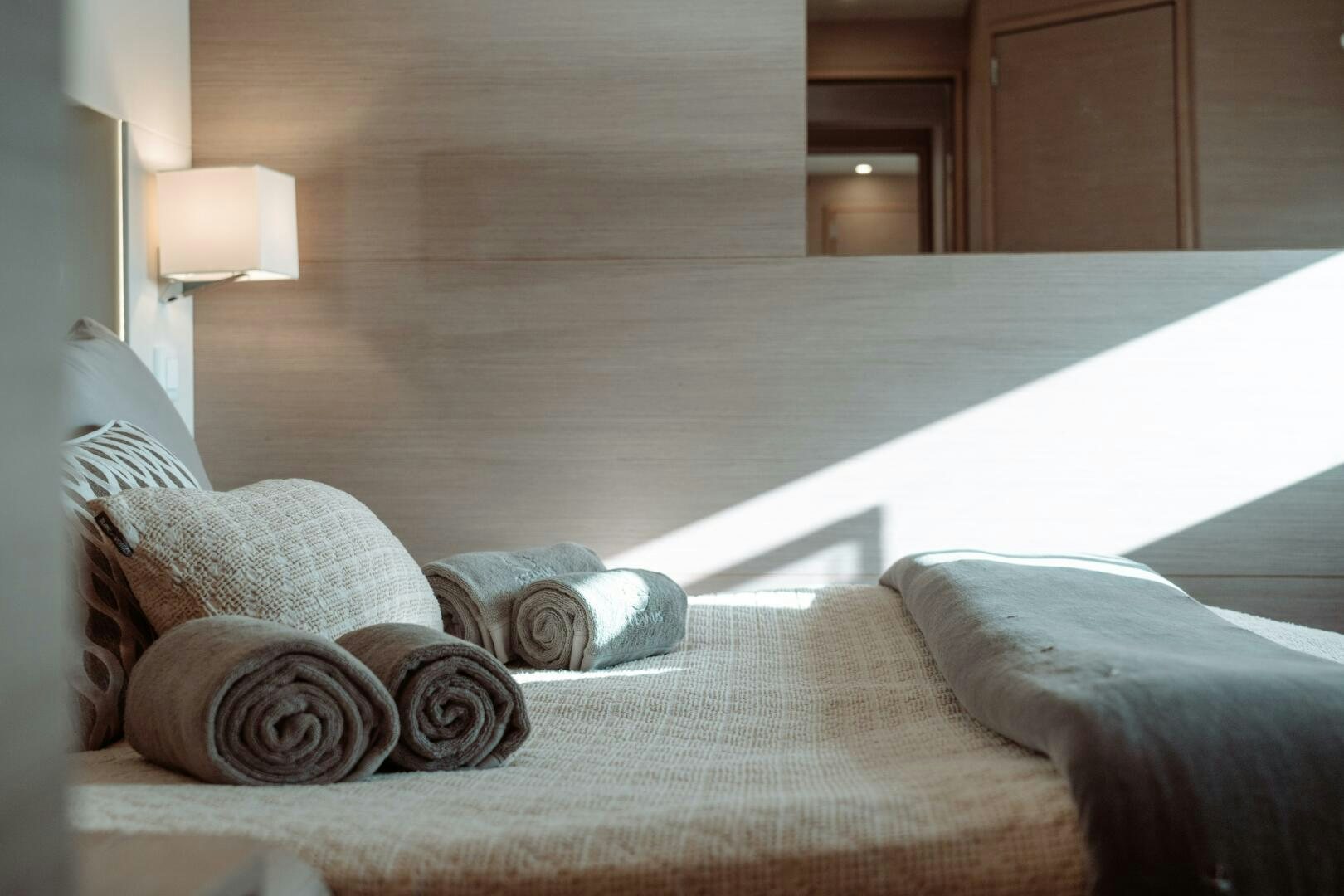 a bed with pillows aboard OCEANUS Yacht for Sale