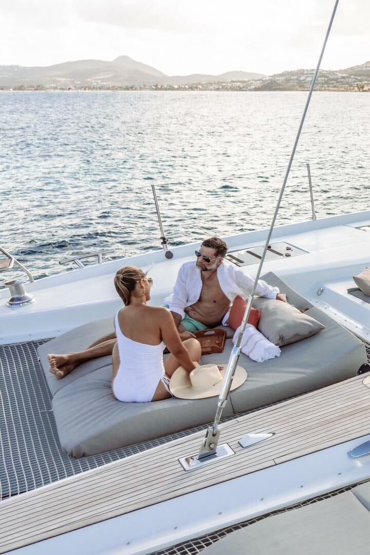 a man and woman sitting on a boat aboard OCEANUS Yacht for Sale