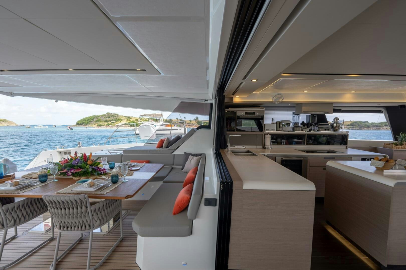 a room with a table chairs and a view of the ocean aboard OCEANUS Yacht for Sale