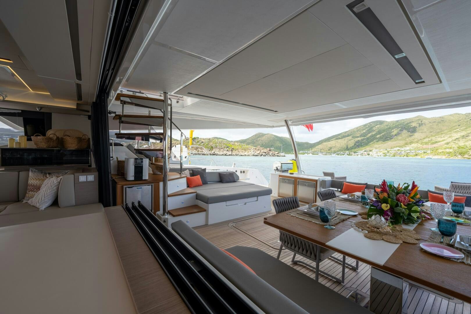 a room with a table and couches aboard OCEANUS Yacht for Sale