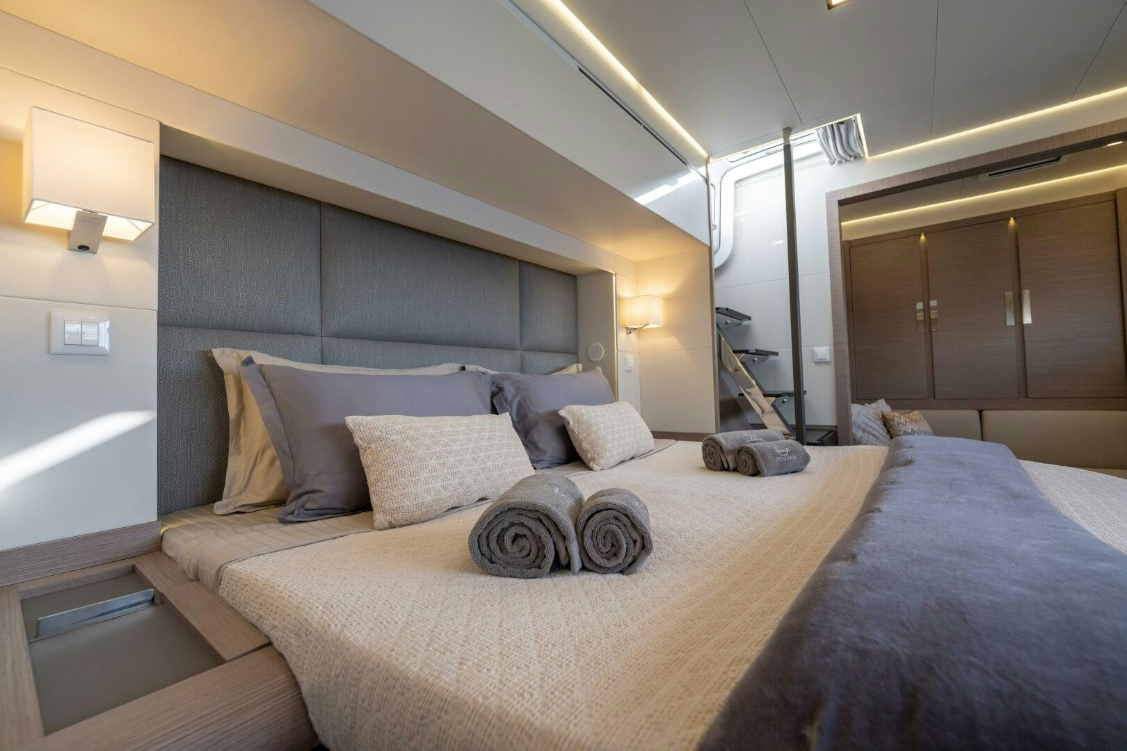 a bed with a blue blanket aboard OCEANUS Yacht for Sale