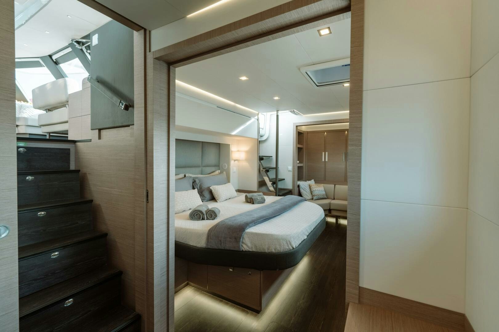 a bedroom with a bed and a mirror aboard OCEANUS Yacht for Sale