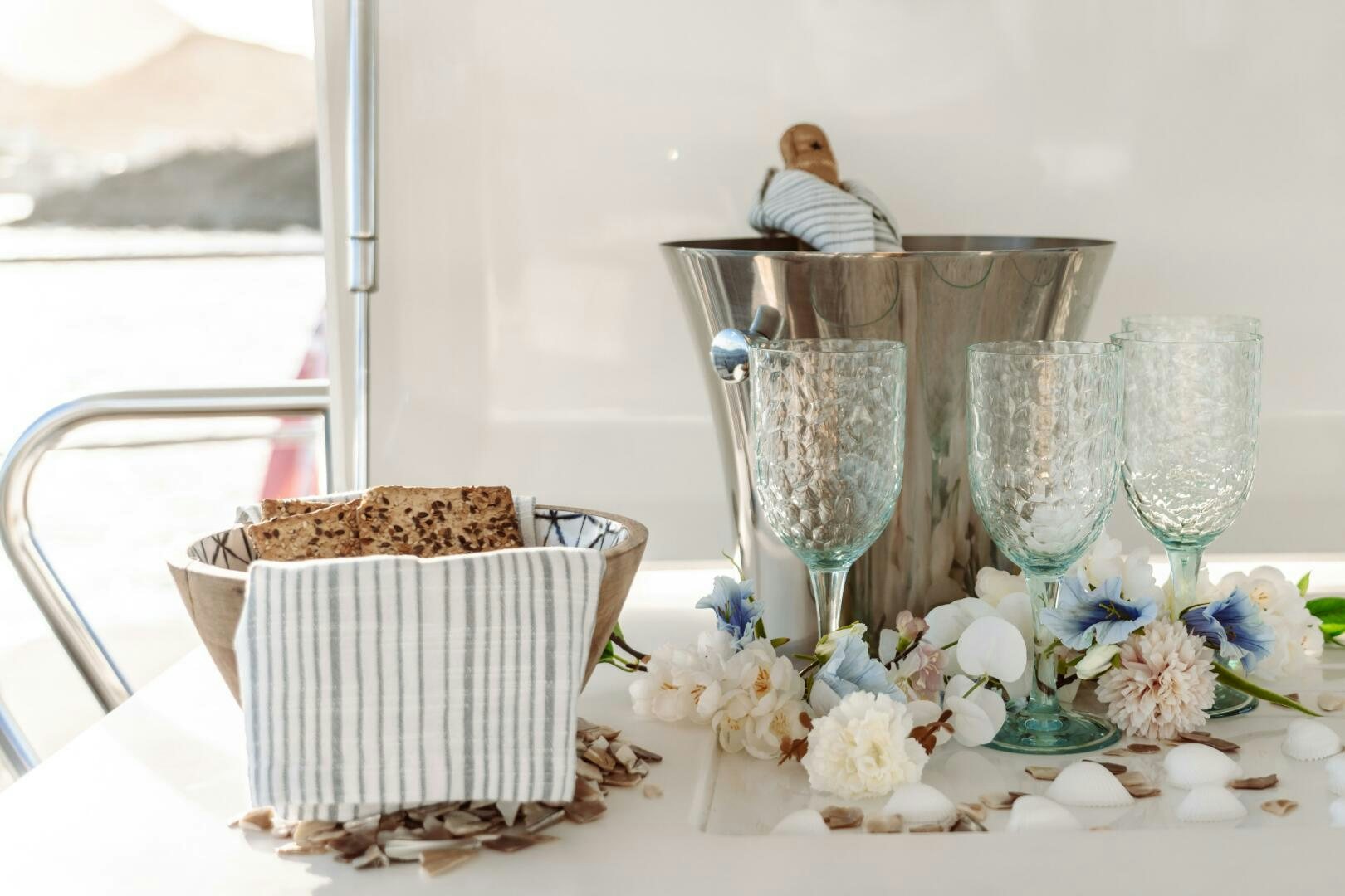 a table with champagne glasses and flowers aboard OCEANUS Yacht for Sale
