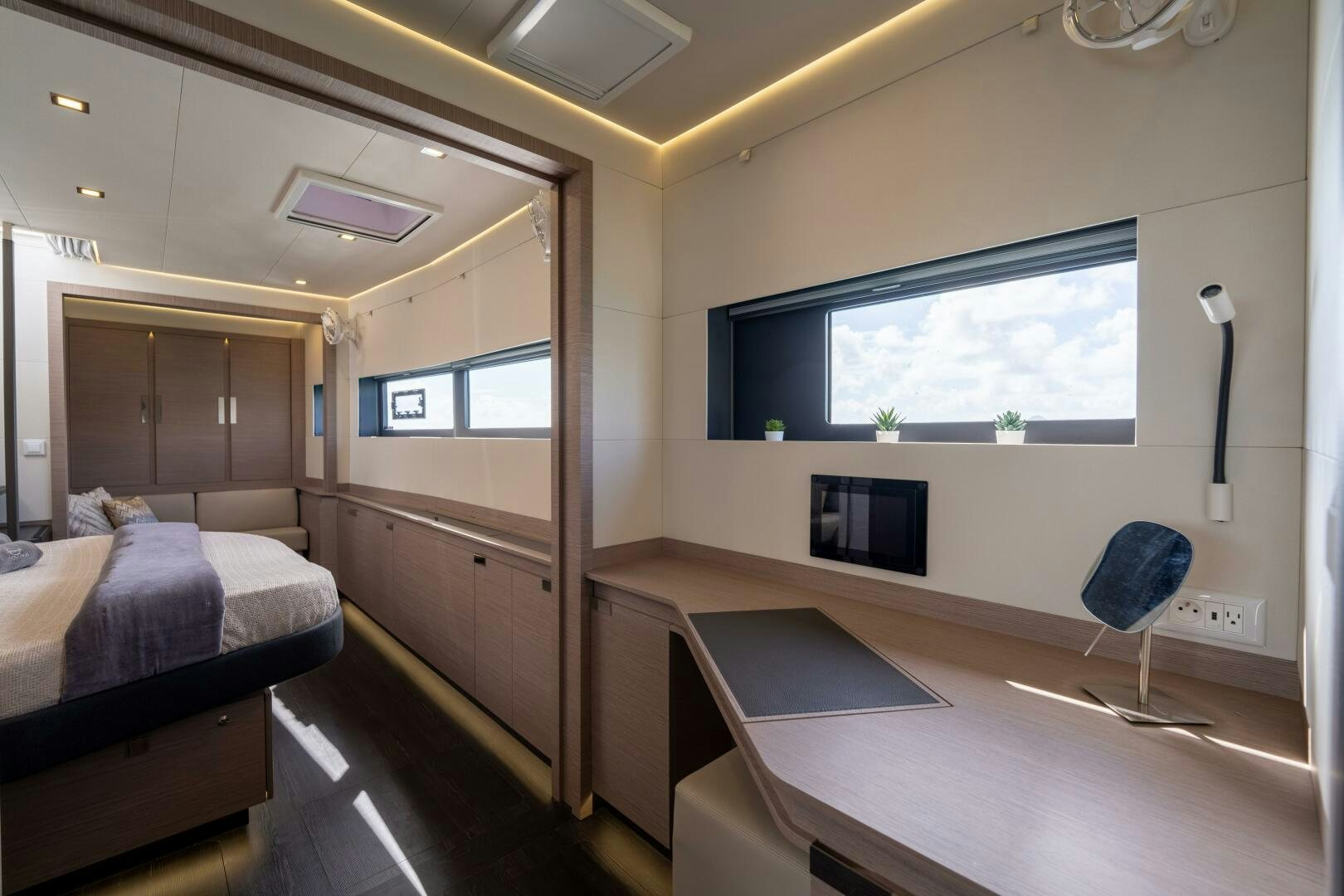a room with a bed and a tv aboard OCEANUS Yacht for Sale