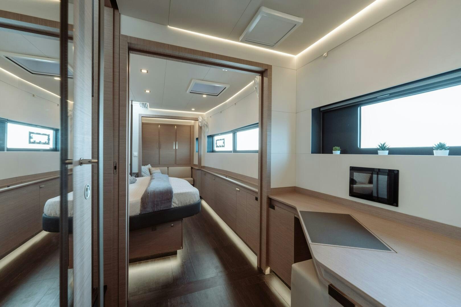 a room with a bed and a television aboard OCEANUS Yacht for Sale