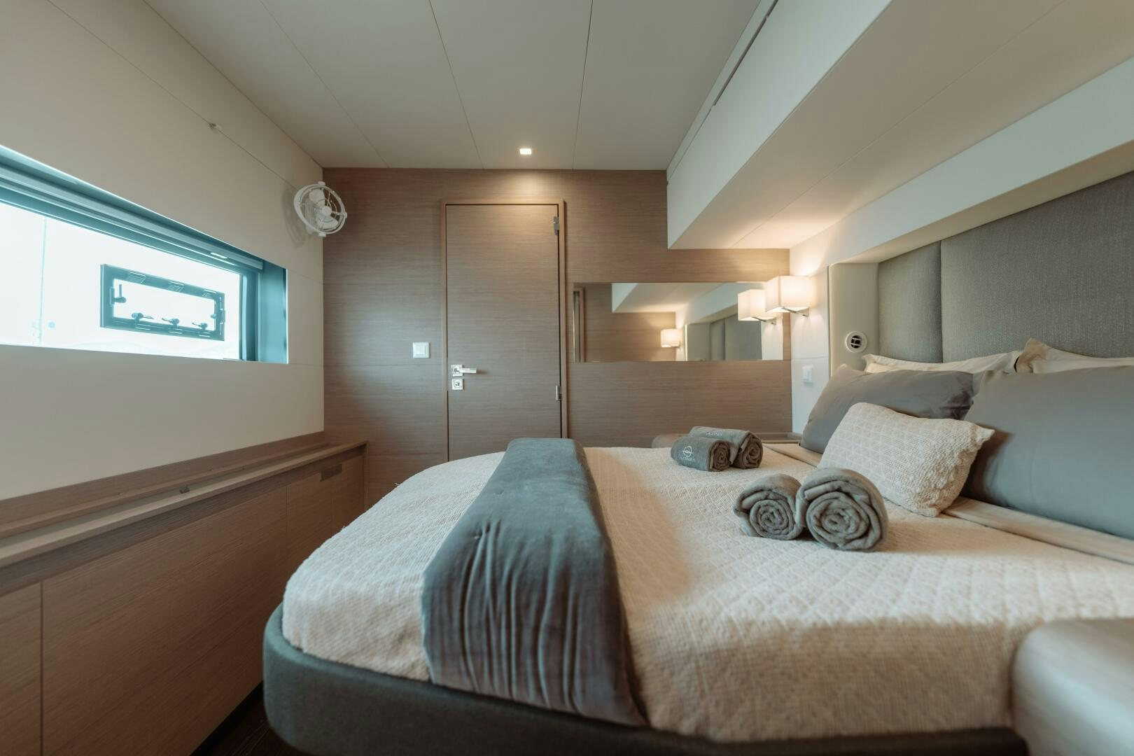 a bed with a blue blanket aboard OCEANUS Yacht for Sale