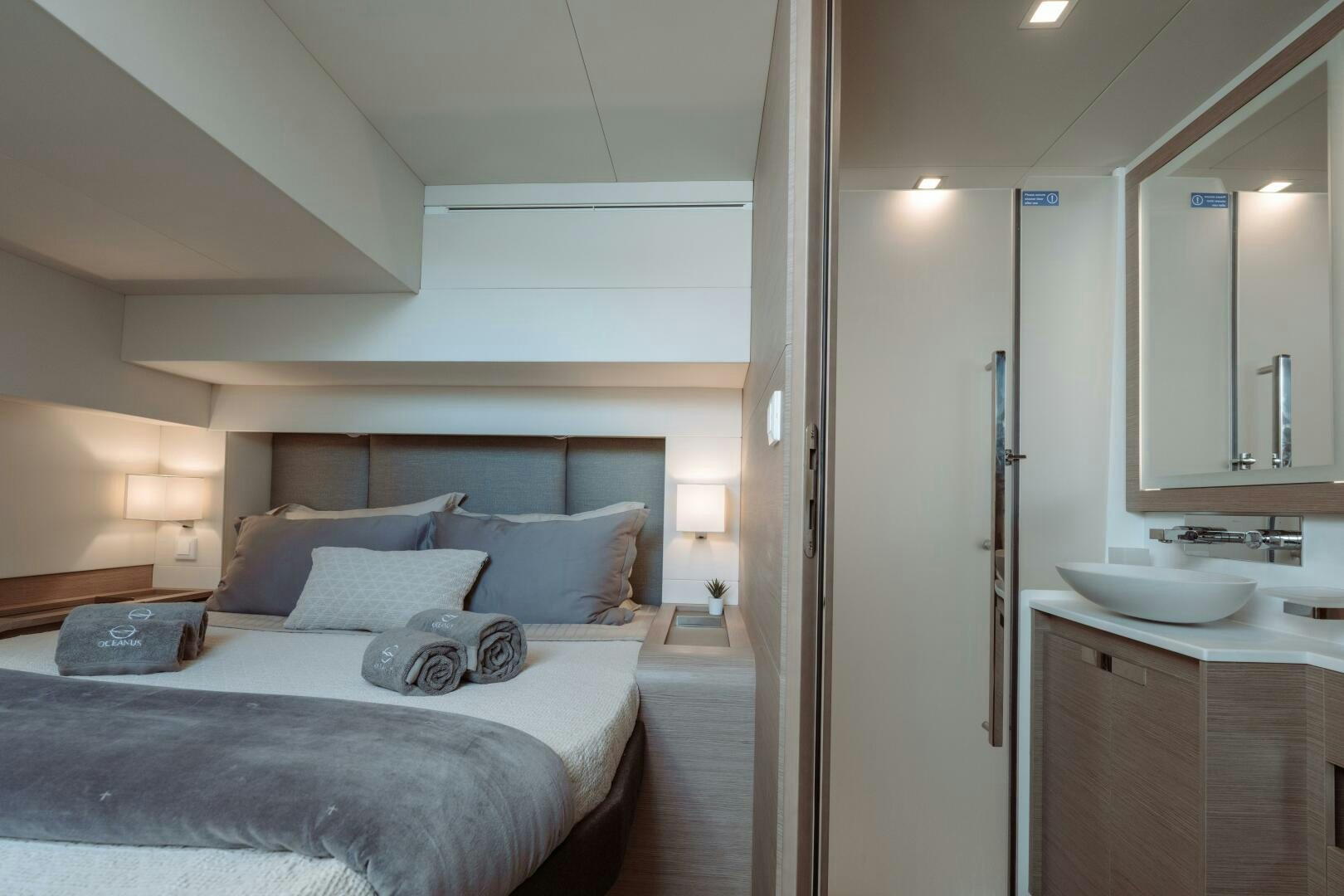 a bedroom with a bed and a sink aboard OCEANUS Yacht for Sale