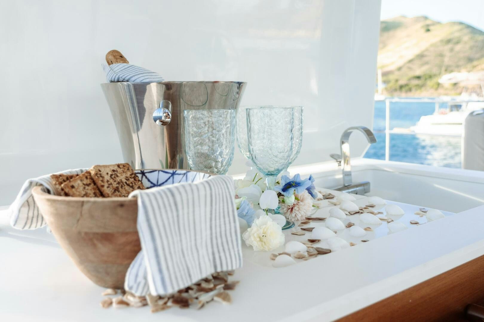 a table with a glass and a bowl of food on it aboard OCEANUS Yacht for Sale