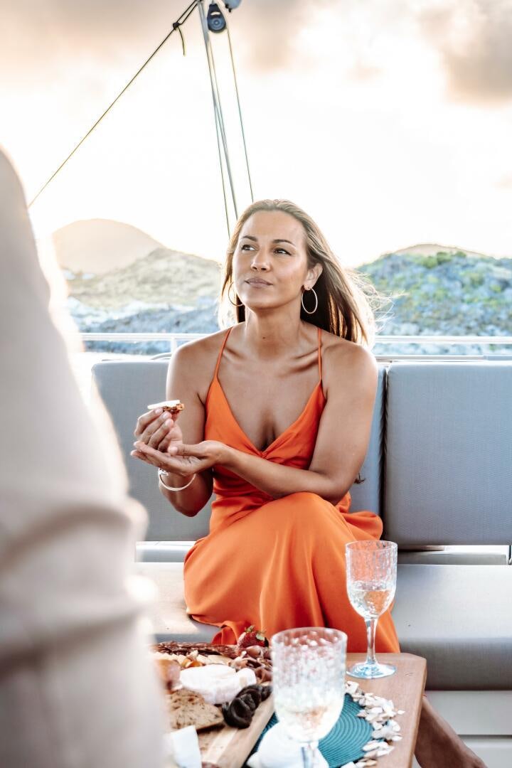 a woman sitting at a table aboard OCEANUS Yacht for Sale