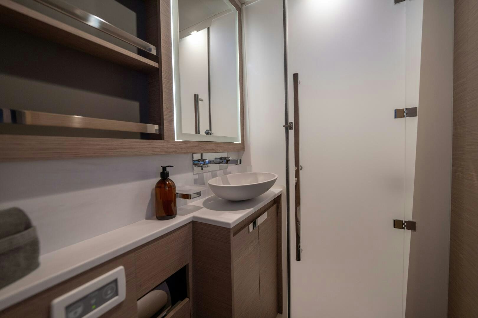 a sink and a mirror in a bathroom aboard OCEANUS Yacht for Sale