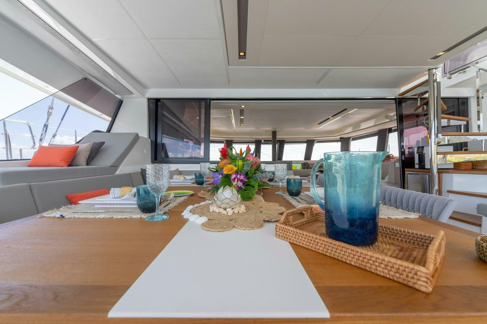 a table with a vase and glasses aboard OCEANUS Yacht for Sale