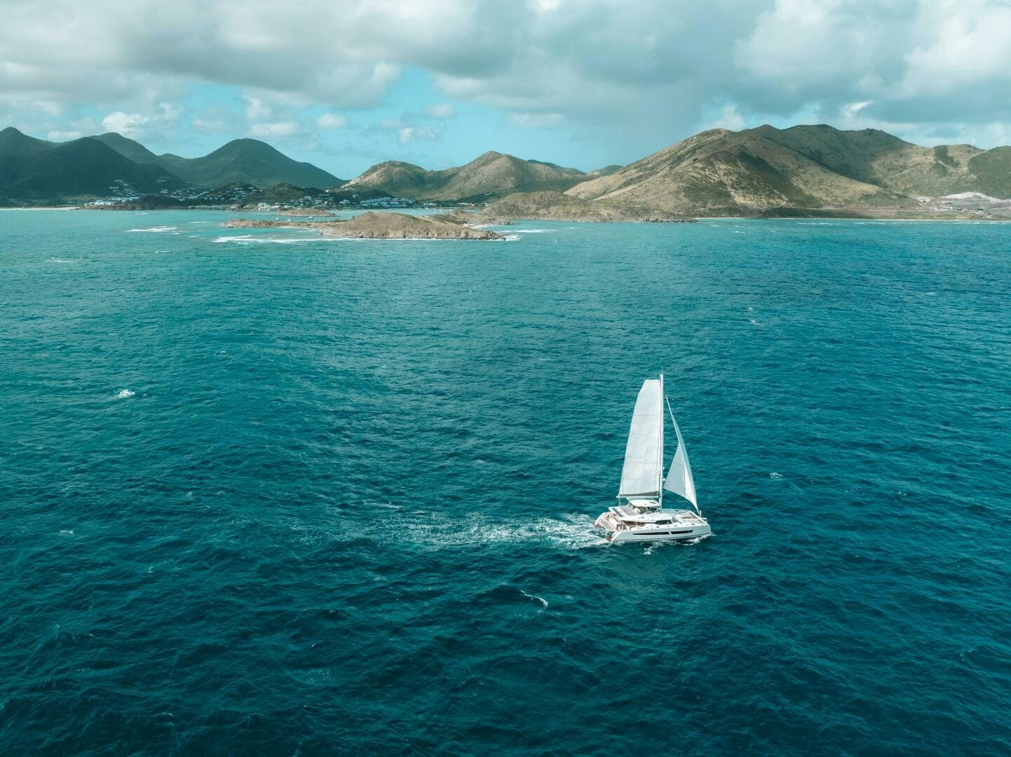 a sailboat on the water aboard OCEANUS Yacht for Sale