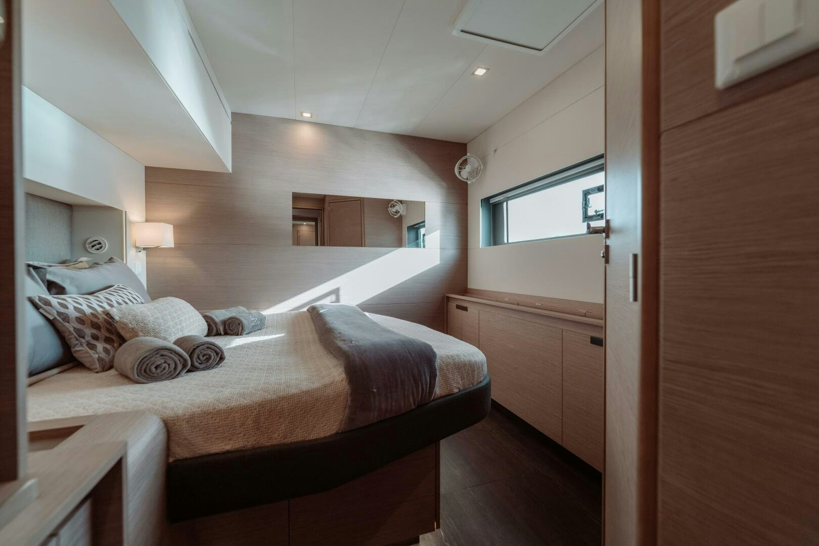 a bedroom with a bed and a mirror aboard OCEANUS Yacht for Sale