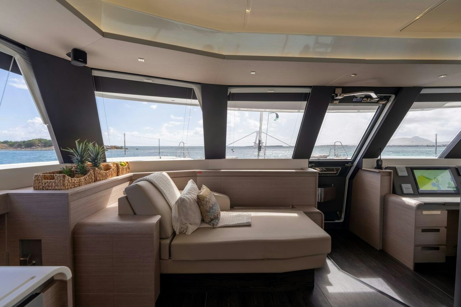 a room with a couch and a table and a window aboard OCEANUS Yacht for Sale
