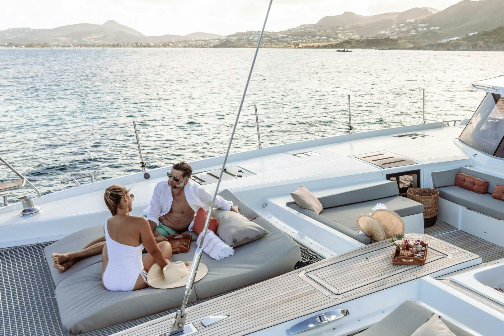 a man and woman sitting on a boat aboard OCEANUS Yacht for Sale
