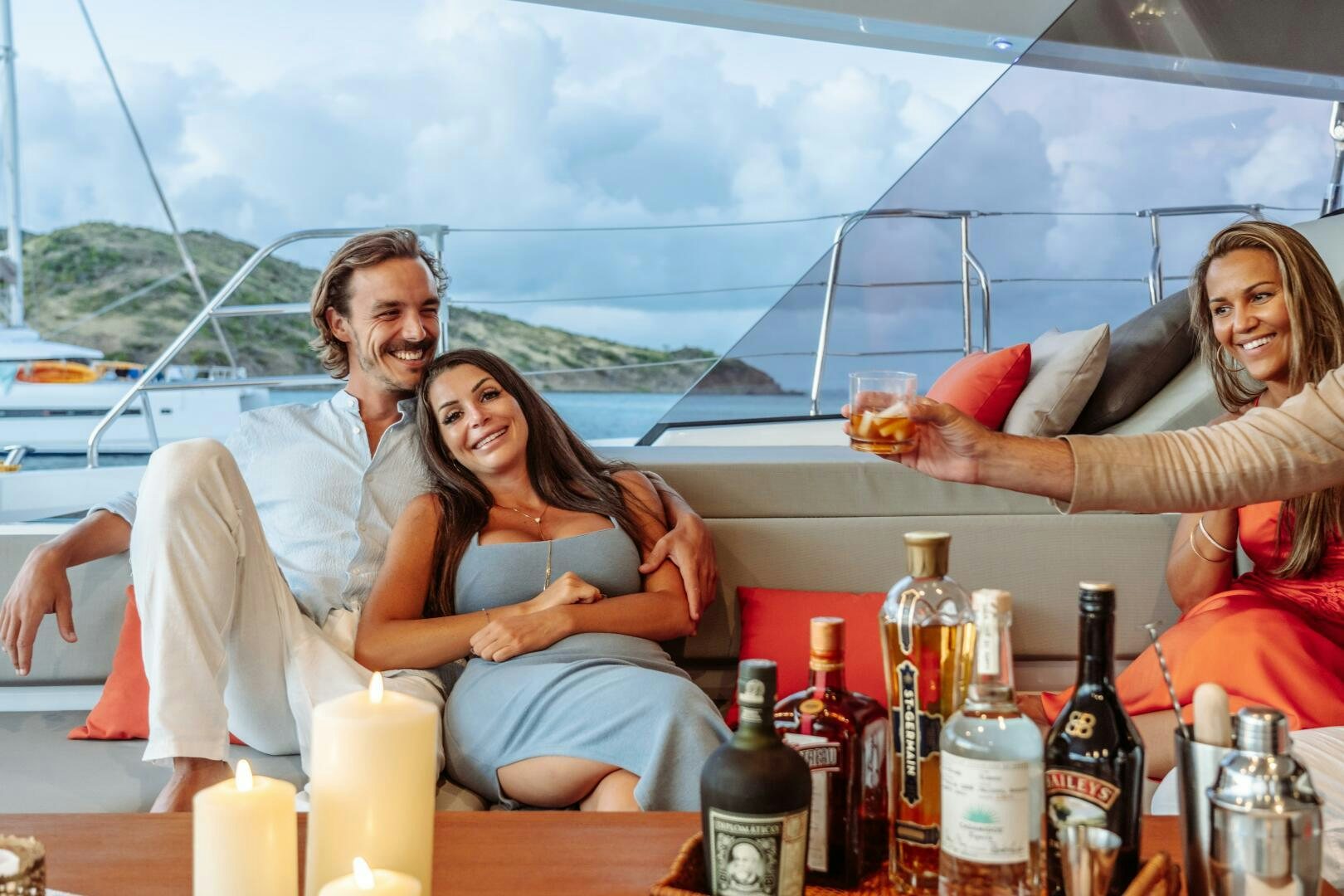 a group of people sitting on a boat with drinks and food aboard OCEANUS Yacht for Sale