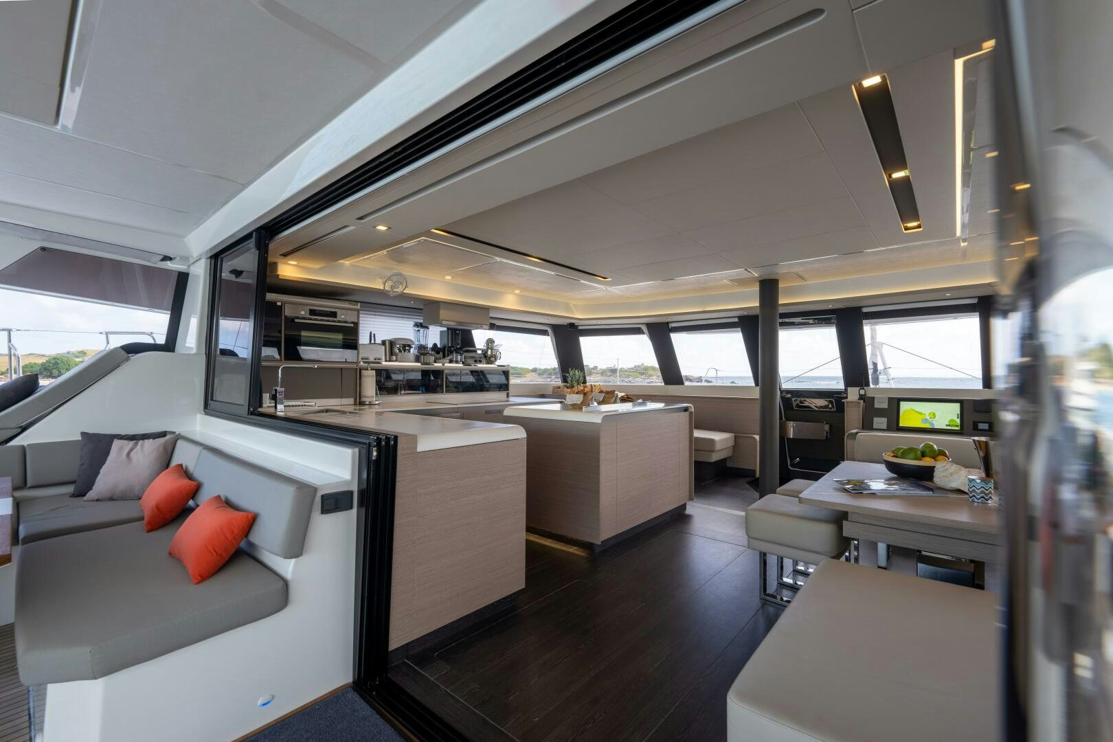 a room with a couch and a table and a large window aboard OCEANUS Yacht for Sale