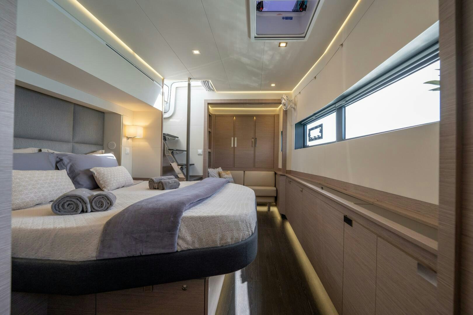a bedroom with a bed and a window aboard OCEANUS Yacht for Sale