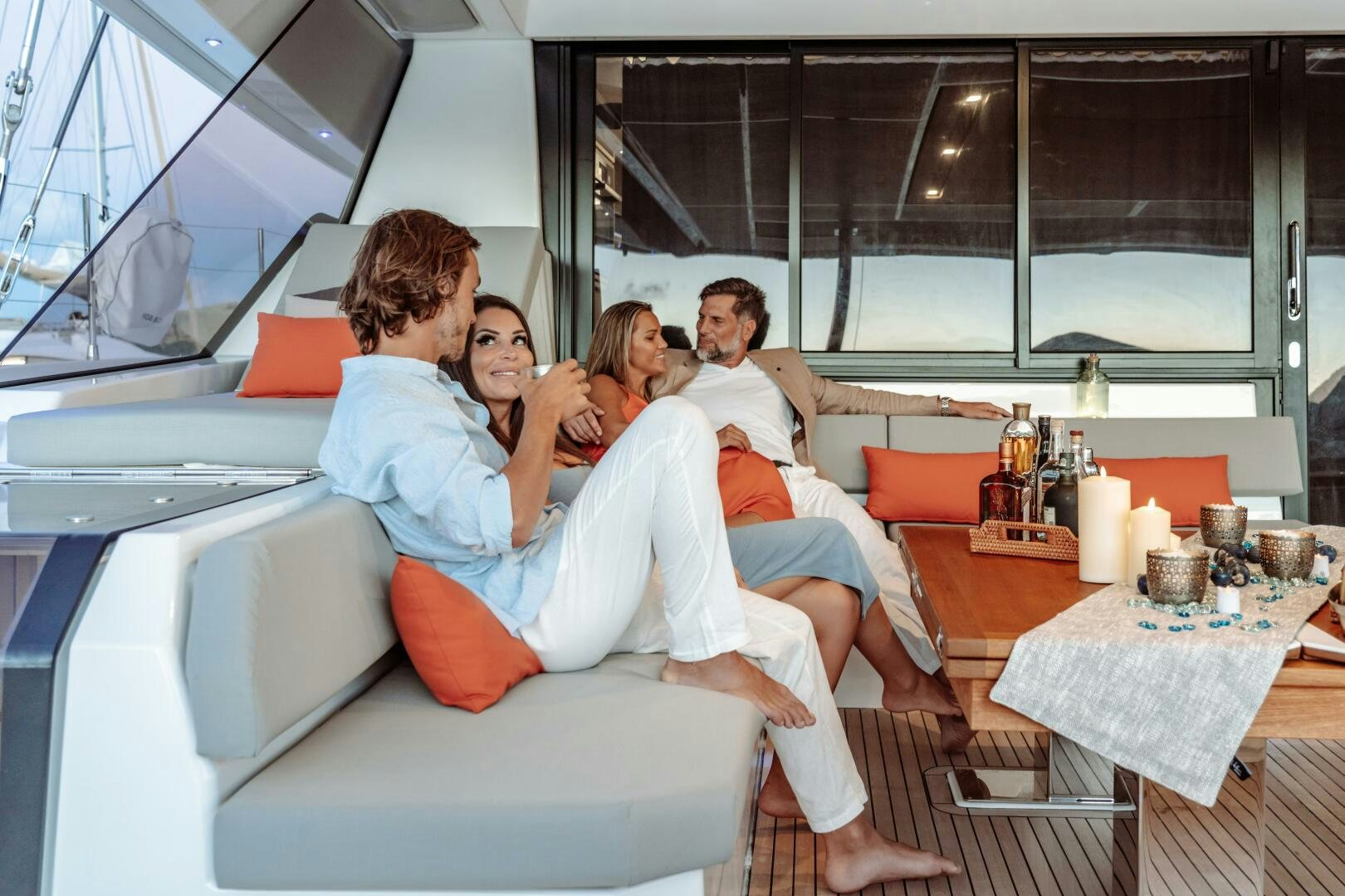 a group of people sitting on a couch aboard OCEANUS Yacht for Sale
