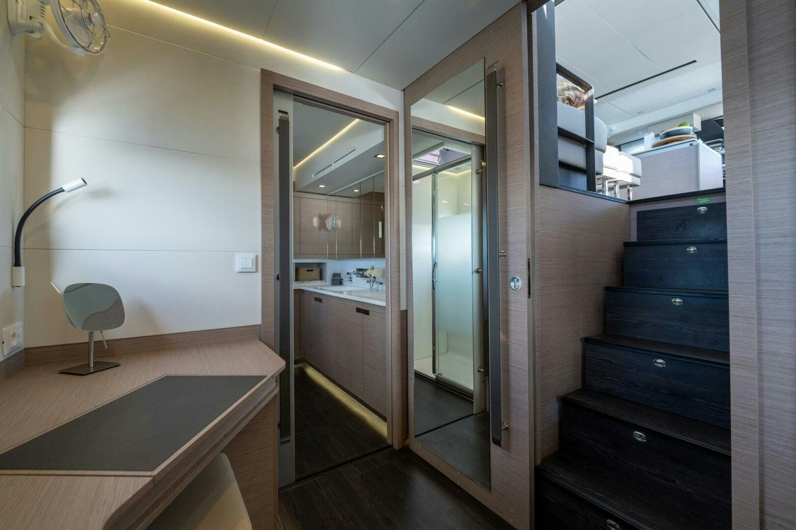 a room with a door and a mirror aboard OCEANUS Yacht for Sale