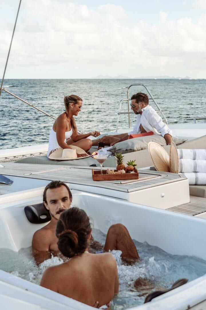 a group of people sitting on a boat aboard OCEANUS Yacht for Sale
