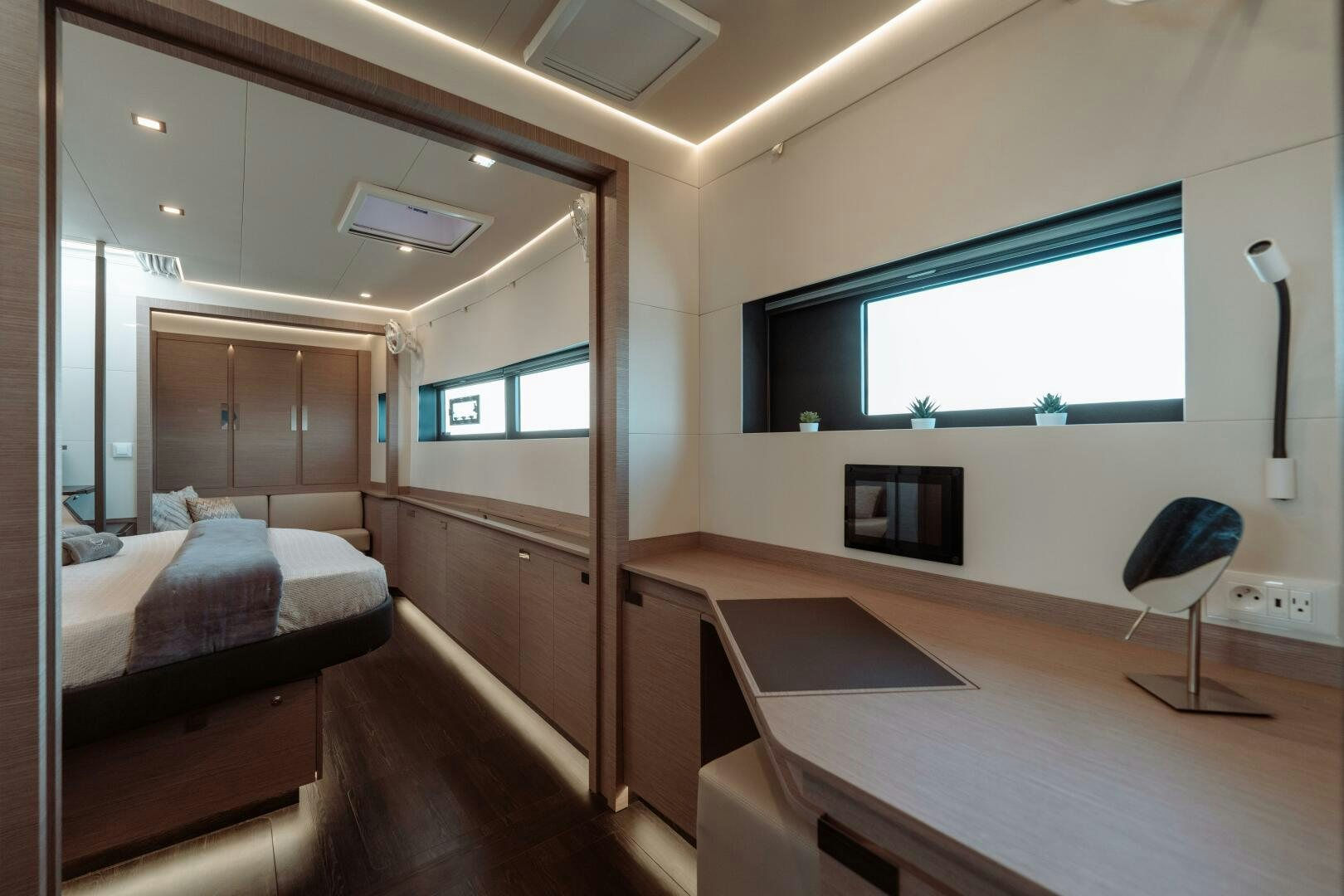 a room with a bed and a desk aboard OCEANUS Yacht for Sale