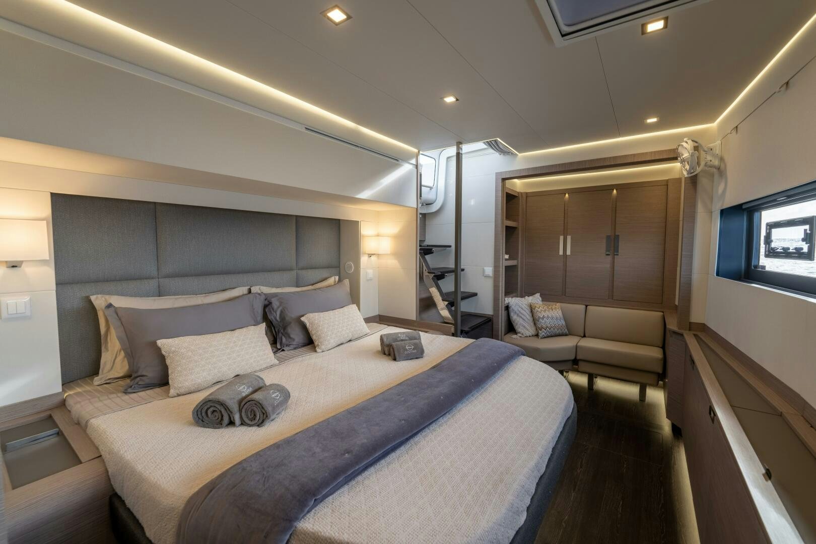 a bedroom with a bed and a couch aboard OCEANUS Yacht for Sale